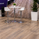 K&S International Flooring LVP Comfort Interlocking Tiles exhibit booth featuring realistic wood-look flooring, portable interlocking tile samples in multiple colors, product benefits, and a modern tradeshow display.

